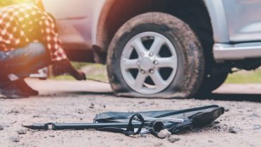 Emergency roadside kit for car breakdowns and tire repairs.