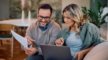 Family planning with digital Bible resources on a laptop and tablet.