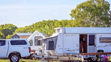 RV and caravan parked at a scenic campsite in Australia.