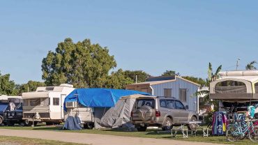 Caravan park with caravans, tents, and outdoor equipment at Big Lap Bible, a popular camping destina.