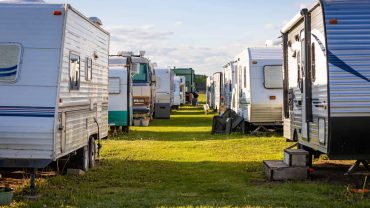 Caravan park with RVs and caravans in a scenic outdoor setting.