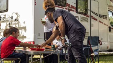 Enjoying outdoor meals and socialising at a campsite with a motorhome.