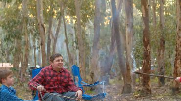 Big Lap Bible camping trip with friends in the forest, enjoying a campfire and outdoor adventure.
