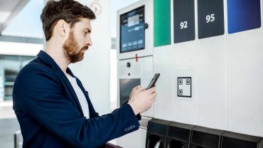 Electric vehicle charging station with digital display and payment options.
